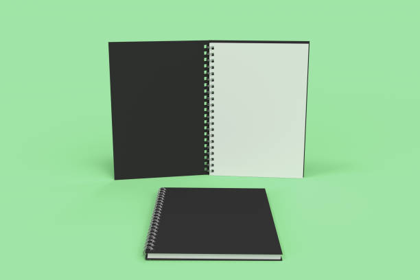 istock Two notebooks with spiral bound on green background 826935830