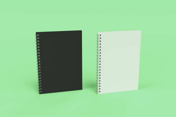 istock Two notebooks with spiral bound on green background 826935998