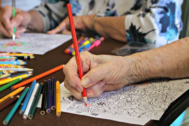 Senior hand coloring With colored pencils and coloring sheet Coloring stock pictures, royalty-free photos & images