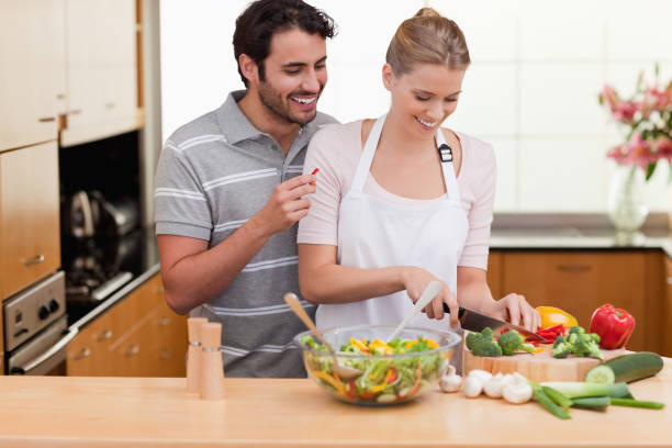 istock Couple slicing vegetables 826939750