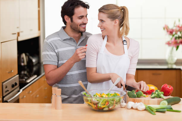 istock Young couple slicing vegetables 826939760