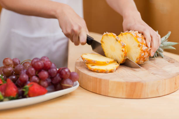 istock Close up of a pineapple being sliced 826940048