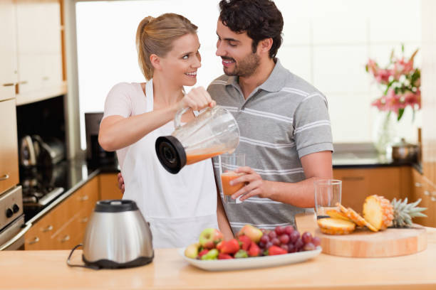 istock Young couple making fresh fruits juice 826940182