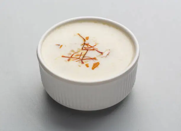 Kheer is a rice pudding from the cuisine of the Indian subcontinent, made by boiling rice, broken wheat, tapioca, or vermicelli with milk and sugar; it is flavoured with cardamom, raisins, saffron, cashews, pistachios or almonds. It is typically served during a meal or as a dessert.
