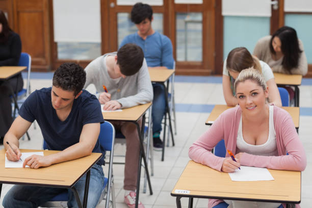 istock Students sitting at the exam room concentrating 826947178