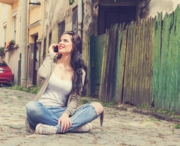 istock Cute girl using cellphone on the street. 826951384