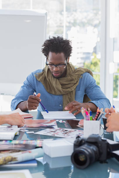 istock Photo editor brainstorming with his colleagues 826954850