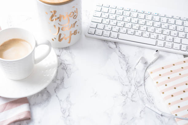 istock Cup of coffee, notepad and keyboard on white marble table 826958794