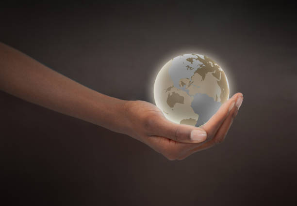 istock Feminine hand holding a glowing planet globe 826959114