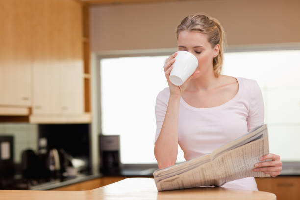 istock Woman reading the news while having coffee 826962734
