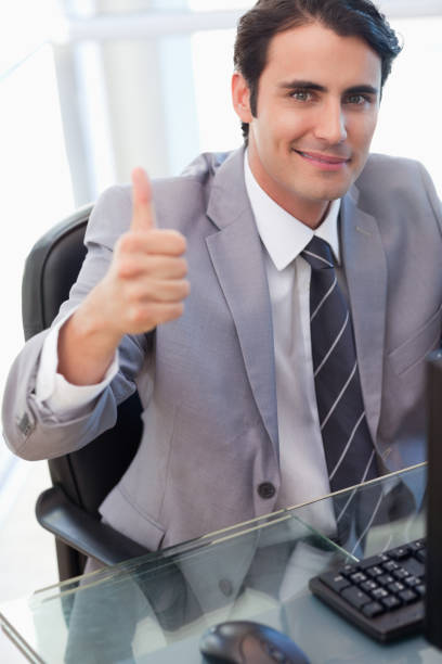 istock Portrait of a businessman working with a computer with the thumb up 826963208