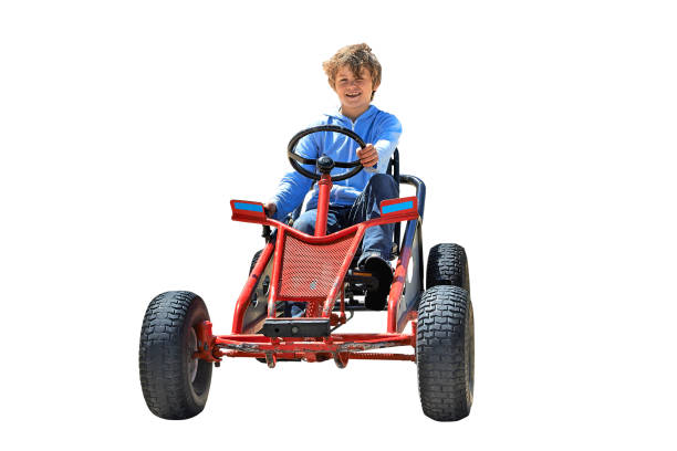 Young boy driving a Quadricycle isolated on white. Clipping Path