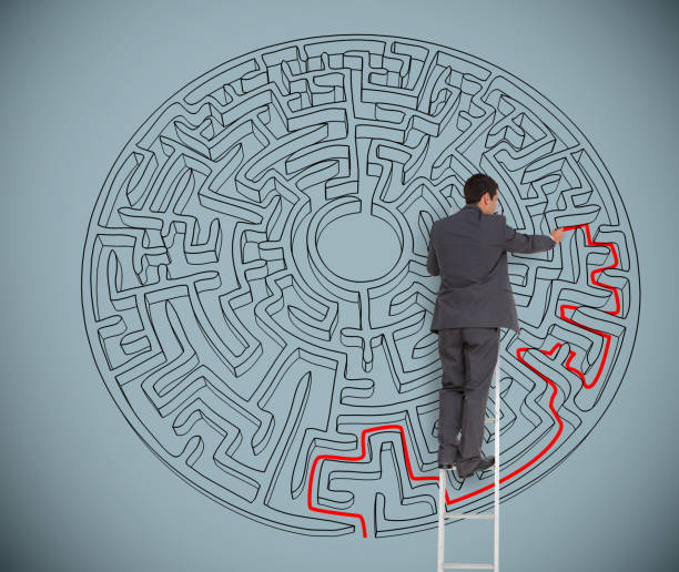 istock Businessman drawing red line to solve a maze 826974422