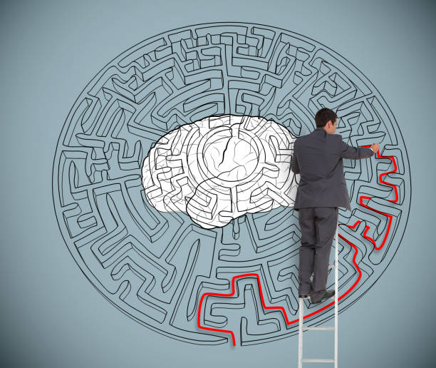 istock Businessman trying to solve a large maze with a brain illustration 826974534