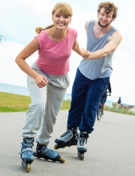 istock Woman encourage man to do rollerblading 826974776