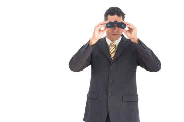 istock Businessman looking at the camera with binoculars 826974850