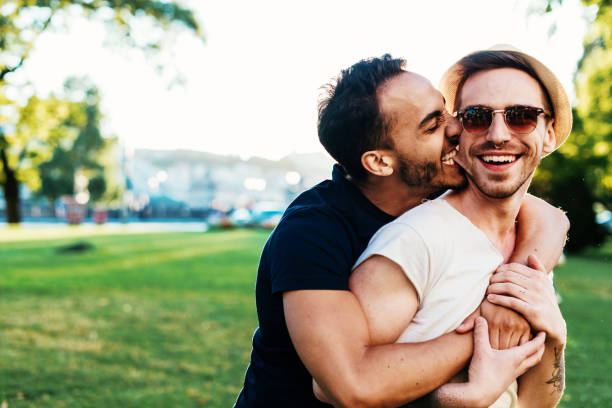 istock Multi ethnic gay couple kissing and biting 826978134