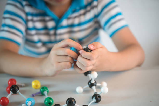 istock one asian boy playing ball and stick structure in the classroom 826978368