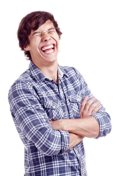 Laughing man Portrait of young hispanic man wearing glasses and blue shirt standing with crossed arms and laughing out loud with closed eyes isolated on white background - laughter is best medicine concept man laughing hard stock pictures, royalty-free photos & images