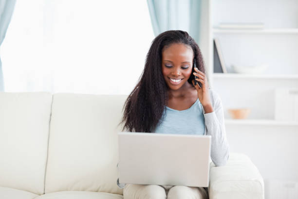 istock Woman with laptop and smartphone on the sofa 826982294