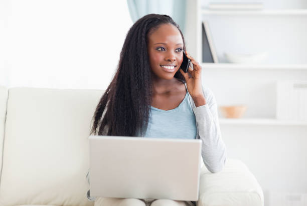 istock Woman with smartphone and laptop on the sofa 826982300