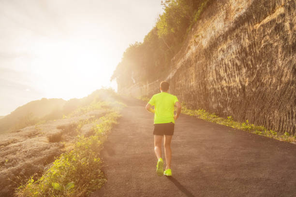 istock Jogging / running up the hill at sunset / sunrise. 826982464