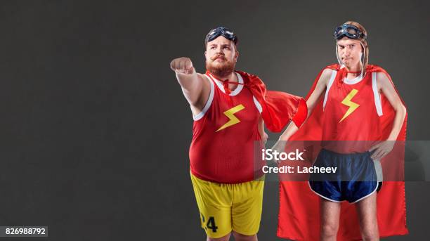 Two Funny Men In Suits Of Superheroes Thin And Fat People Stock Photo - Download Image Now - iStock Two Funny Men In Suits Of Superheroes Thin And Fat People Stock Photo - Download Image Now - iStock