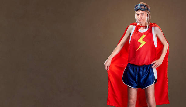 istock Thin, funny man in a superhero costume. 826988868