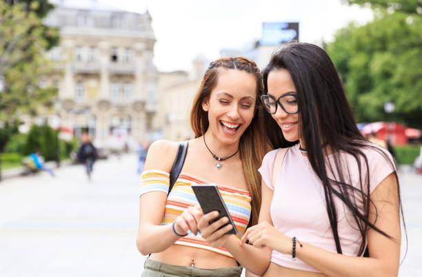 istock Girls hanging out and using smart phone on street 826988996