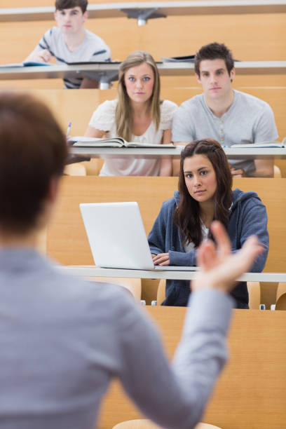 istock Students sitting at the lecture hall listening 826990778