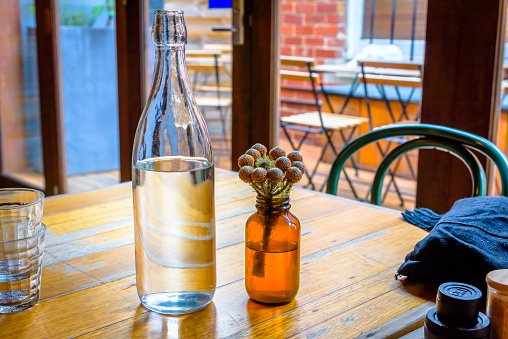 A bottle of water on a cafe table