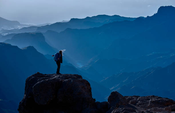 istock hiker woman silhouette admiring the mountains 827000340