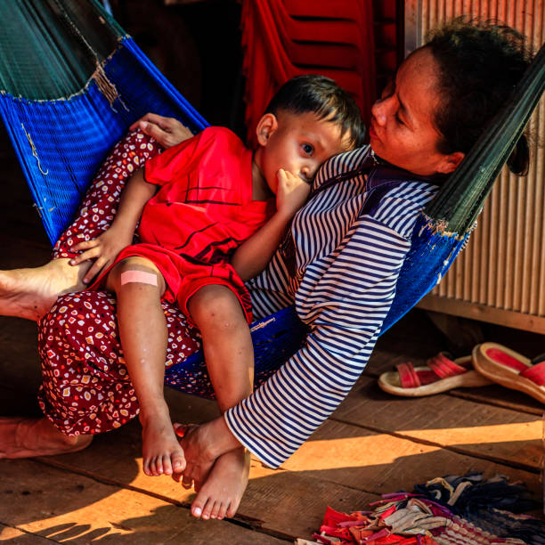 istock Cambodian mother with her son lie on the hammock, Cambodia 827007744