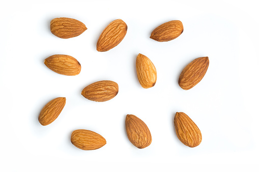 Group of organic almond nuts with isolated white background