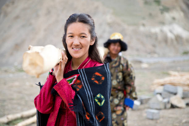 istock Woman and man carrying bamboo 827010460