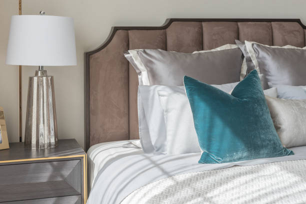 istock classic bedroom style with set of pillows and lamp on table side 827015284