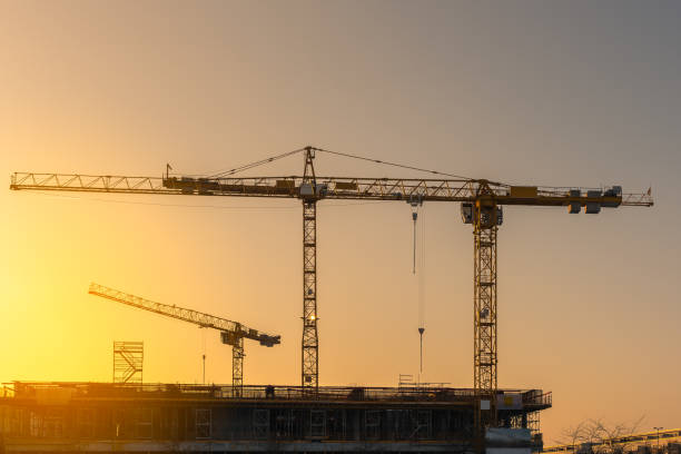 istock Industrial construction cranes and building silhouettes 827015326