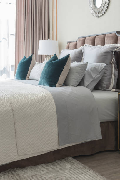 istock classic bedroom style with set of pillows and lamp on table side 827015344