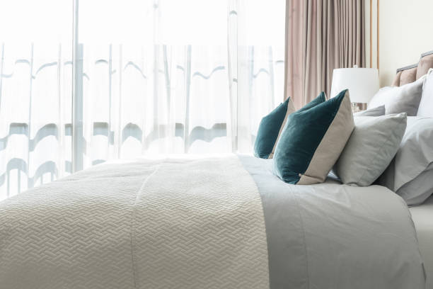 istock classic bedroom style with set of pillows and lamp on table side 827015394