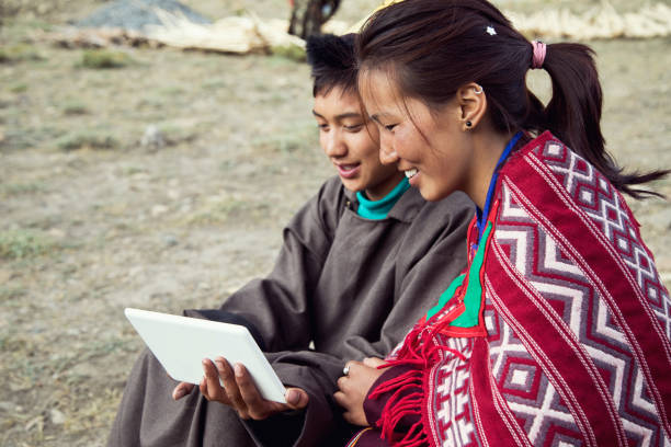 Man and woman using digital tablet Man and woman in traditional clothing using digital tablet at Spiti lahaul and spiti district photos stock pictures, royalty-free photos & images