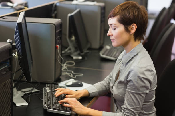 istock Woman sitting at the computer at the computer room 827018904