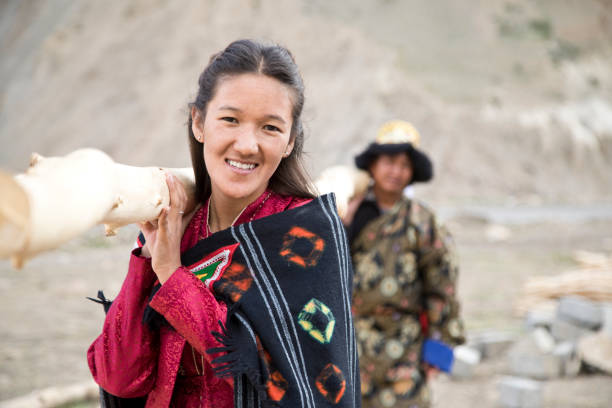 Portrait of woman and man carrying bamboo on shoulders