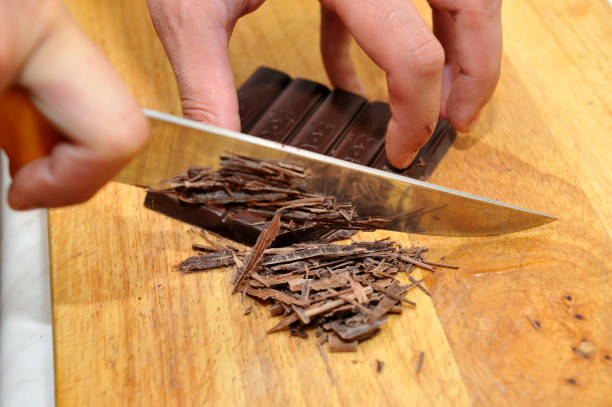 istock Chopping bar chocolate for making tasty cake in the kitchen 827021958