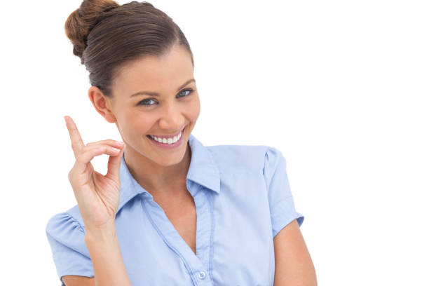istock Smiling businesswoman pointing upwards 827025346