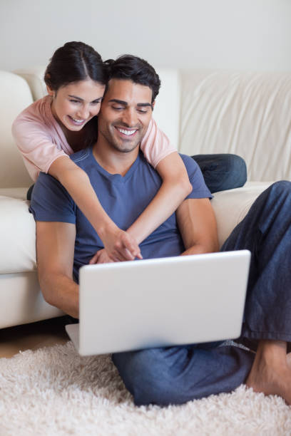 istock Portrait of a charming couple using a laptop 827025904