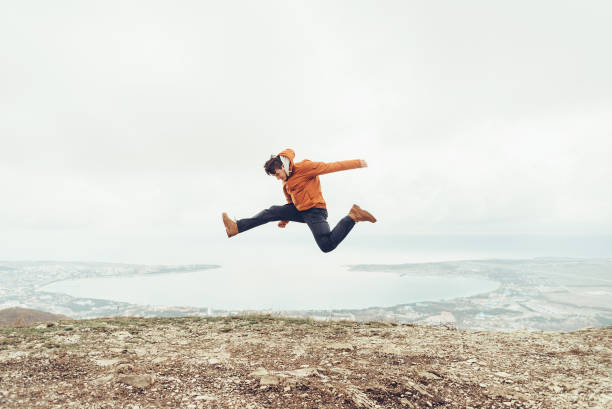 istock Happy guy jumping outdoor. 827026296