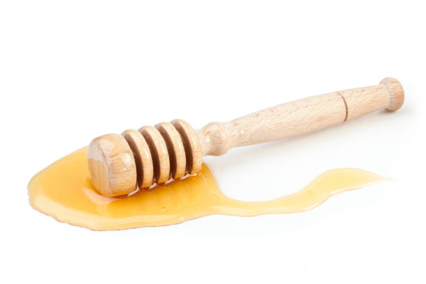 istock Honey dipper on the floor spilling honey 827033200
