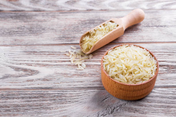istock Rice in a bowl on wooden background 827037692