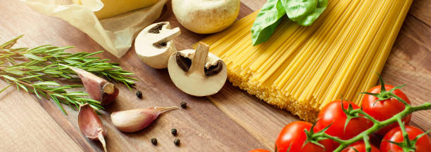 istock Ingredients for pasta and sauce. Top view, view from above. Copy space. Dark background. banner 827045090