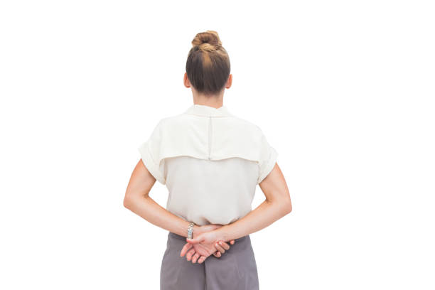 Businesswoman with hands behind her back Businesswoman with hands behind her back on white background hands behind back stock pictures, royalty-free photos & images